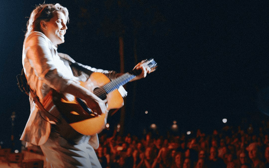 Brandi Carlile performing on stage in front of a crowd